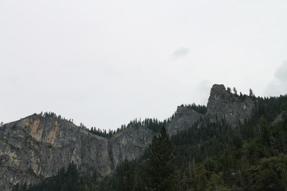 rock mountains lined with trees