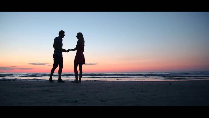 romantic couple engaged at sunset