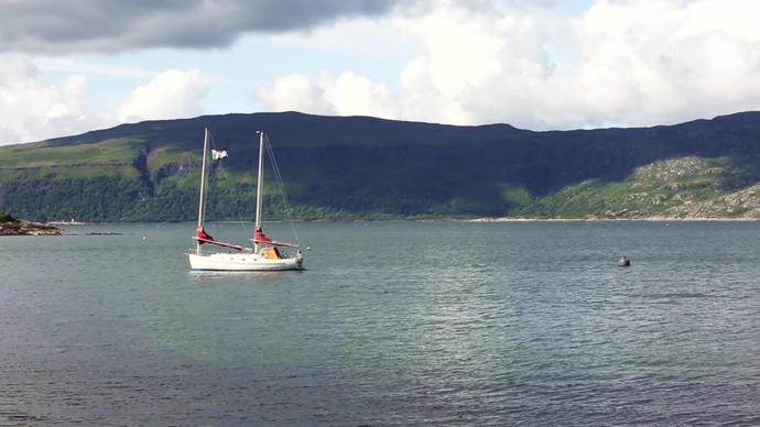 sailing boat anchoring on calm lake
