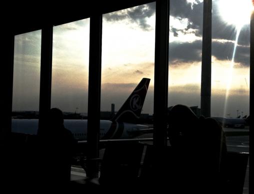 silhouette of plane tail at airport