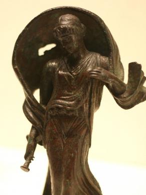 small bronze statue of a woman