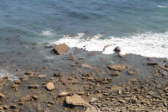 soft ocean waves on beach rocks