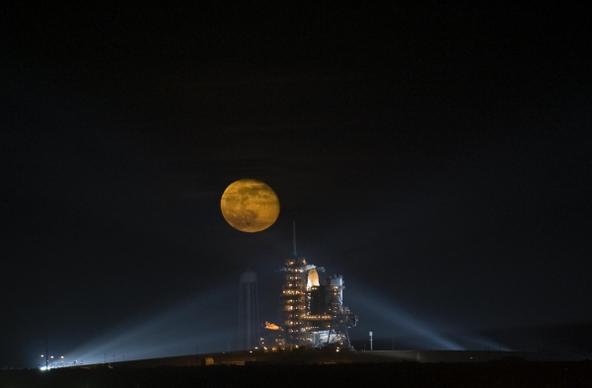 rocket launching pad under bright round moon