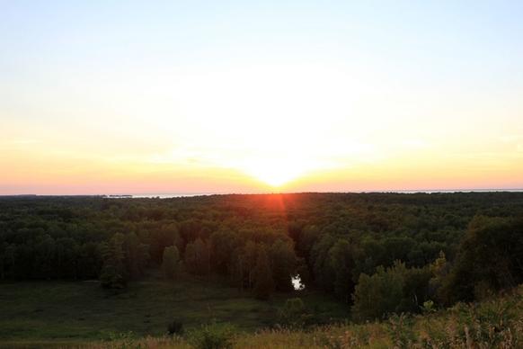sun setting over forest at potawatomi state park wisconsin