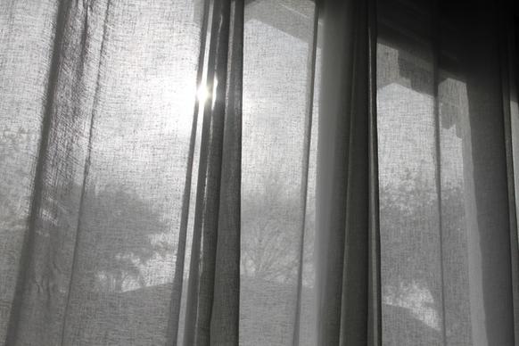 sun shining through thin curtains