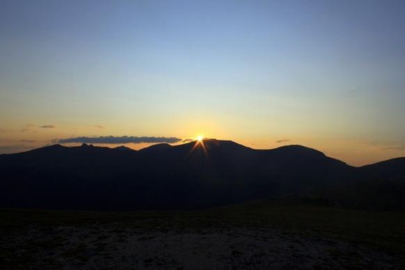 sunrise in the distance at rocky mountains national park colorado