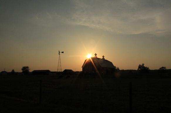 sunset behind barn at prophetstown state park indiana