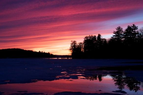 sunset winter ice lake water trees clouds