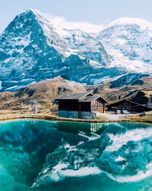 switzerland scenery picture snowy mountain reflection lake cottage 