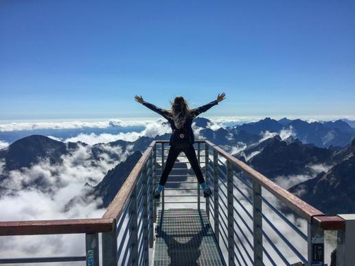 travel lifestyle picture dynamic jumping woman mountain scene