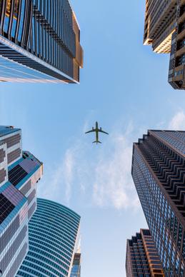 travel picture modern airplane sky buildings lower view