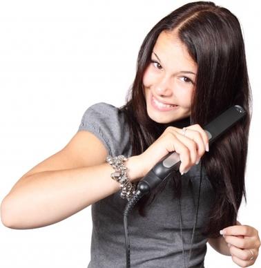 woman with hair straightener